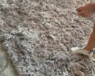 Beautiful champagne and tan fluffy rug with golf foil glinting strings