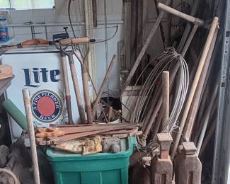 lots of old iron hand and yard tools, old jacks