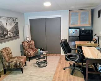 Three chairs, microwave, desk, refrigerator.