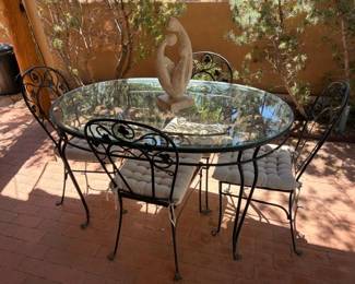 Vintage wrought iron and glass patio table with 4 chairs and cushions