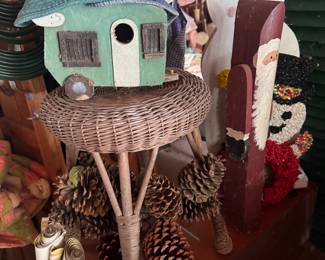 antique wicker stool, bird houses and pine cones 