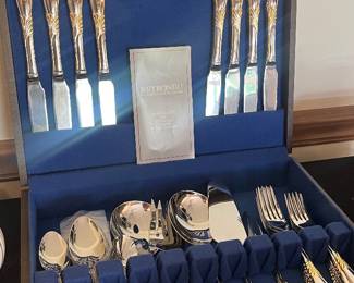 Vintage Linda pattern Retroneu flatware set, with blue velvet fitted wooden storage case. Features dinner knives, forks, spoons, and various serving pieces.