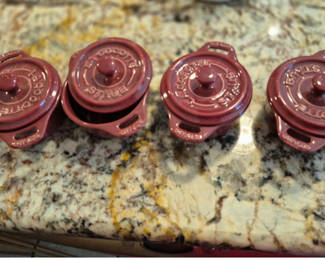 Lot 88: Set of four Staub burgundy ceramic cocottes with lids