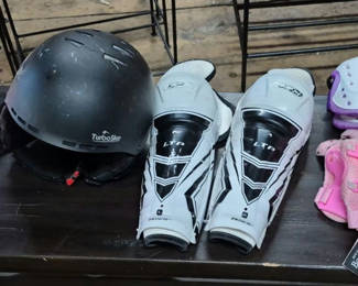 Lot 54: Two Helmets, Shin Guards, and Protective Pad Sets