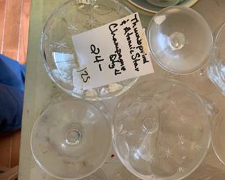#125 set of 4 thumbprint and atomic star champagne glasses $24.00 #126 set of 4 thumbprint and atomic star champagne glasses $24.00