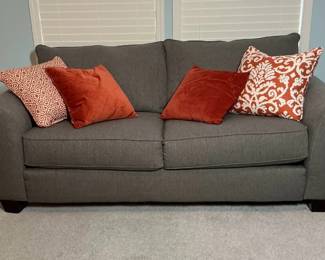 Gray Upholstered Sleeper Couch with Accent Pillows