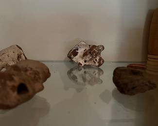 Pre-Columbian or Mayan artifacts with small terracotta figurines and vessel
