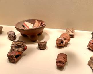 Pre-Columbian or Mayan artifacts with small terracotta figurines and vessel