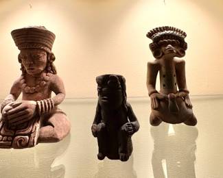 Pre-Columbian or Mayan artifacts with small terracotta figurines and vessel