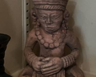 Pre-Columbian or Mayan artifacts with small terracotta figurines and vessel