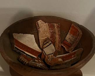 Pre-Columbian or Mayan artifacts with small terracotta figurines and vessel