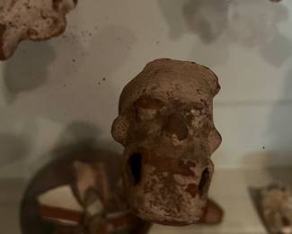 Pre-Columbian or Mayan artifacts with small terracotta figurines and vessel