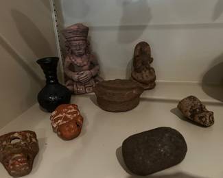 Pre-Columbian or Mayan artifacts with small terracotta figurines and vessel