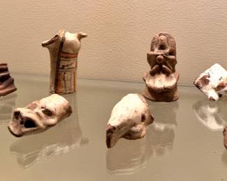 Pre-Columbian or Mayan artifacts with small terracotta figurines and vessel