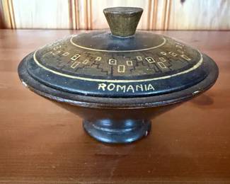 decorative item labeled "ROMANIA" with an etched geometric pattern.