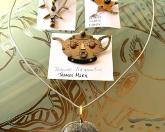 Fun selection of vintage Thomas Mann custom made jewelry including a Techno-Romantic bronze teapot brooch