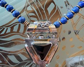 Vintage Tuareg silver and gold pendant w/ mixed semi-precious stones on a strand of lapis beads