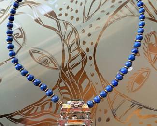 Vintage Tuareg silver and gold pendant w/ mixed semi-precious stones on a strand of lapis beads
