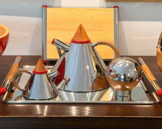 Extremely rare MCM style ‘Futura’ serving set designed by Larry Laslo for Towle Silversmiths.  This set features polished stainless steel with wood accents and is in incredible, mostly unused, vintage condition. 