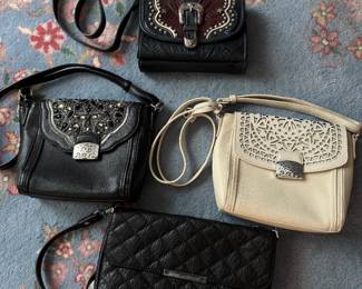 Item #44 - American West Black Purse (top) $60       Item #45 - Brighton Black Purse (middle left)  $50      Item #46 - Brighton Cream Purse (middle right)  $50      Item #47 - Damsel in Defense Black Purse (bottom)  $20