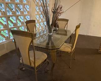 Glass Top Dining Table with Ornate Metal Base and Upholstered Chairs