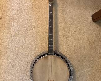 mid 1920s 4 string tenor banjo by Lyon and Healy (Washburn) with an ebony and mother of pearl neck and a mahogany resonator, with original case, overall good condition but the resonator needs a screw