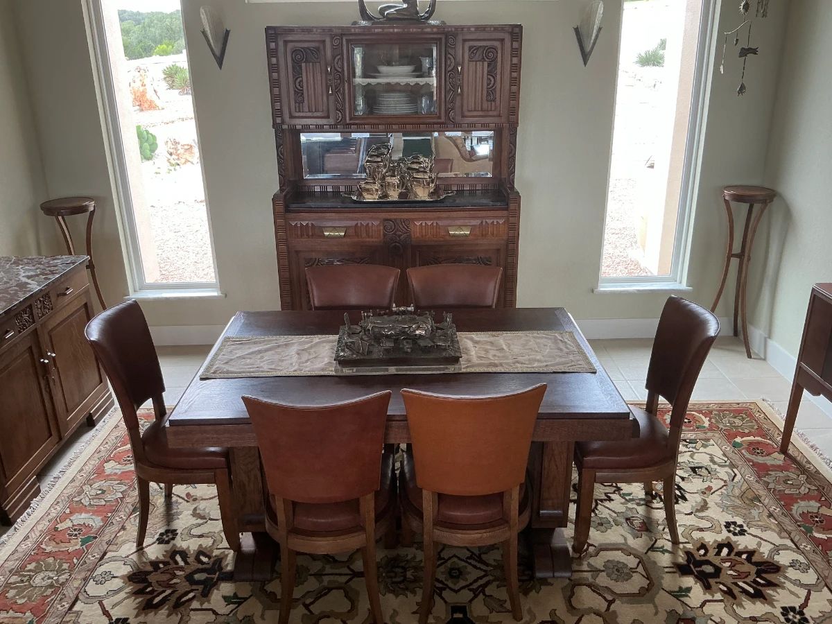 French Art Deco Dining Room Suite, hand-carved from the 1930's outside Paris. Includes Dining Table with 2 leaves, 6 leather chairs, And a fabulous mirrored China cabinet with marble top, with original keys.