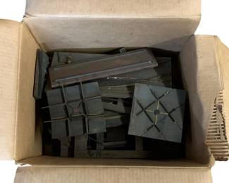 1115 - Box Lot O Scale Train Tracks (Description): A box lot of O scale model train tracks and components. The collection includes various track sections and crossing pieces in a dark finish, suitable for model railroad layouts. Sold as a lot.