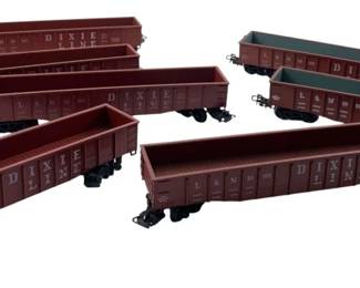 299 - Group Lot of 7 Marklin Cargo Carrier Cars (Description): Group lot of seven Marklin cargo carrier cars. These model train cars feature open-top gondola style designs with detailed exteriors. Each car measures 1 x 2 x 8 inches.