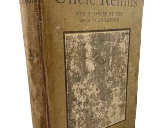 136 - 1905 Told by Uncle Remus Joel C Harris (Description): Told by Uncle Remus: New Stories of the Old Plantation by Joel Chandler Harris, 1905 hardcover edition. The book features a tan cloth binding with darkened spine and cover illustration. The binding shows wear consistent with age, with visible soiling and discoloration to the cover. Published as a collection of new plantation stories in the Uncle Remus series.