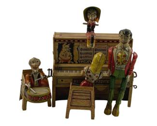 859 - Unique Arts Li'l Abner Dogpatch Band Tin Toy (Description): Unique Arts tin lithographed Li'l Abner and His Dogpatch Band mechanical toy. This colorful wind-up toy features multiple characters from the classic comic strip, including a piano player, drummer, and dancing figure atop the upright piano. The piano displays sheet music reading "Turkey In The Straw" and features decorative pig illustrations. The figures are dressed in typical hillbilly attire with bright reds,