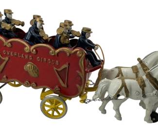 740 - Vtg Kenton Overland Circus Horse Drawn Wagon (Description): Vintage Kenton Overland Circus horse drawn wagon crafted in cast iron. This charming piece features a team of horses pulling an ornate circus wagon with seated figures. Measures 7.5 inches by 15 inches by 4 inches.
