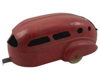 917 - Vtg Red Airstream Metal Toy Trailer As Is (Description): Vintage Airstream metal toy trailer in red paint. This streamlined pressed steel camper trailer features a classic teardrop shape with cutout windows and a single wheel axle. Shows wear consistent with age and play use, offered as is. Measures 5 inches tall by 11 inches long by 6 inches wide.