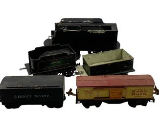 944 - 5pc. Lot Assorted Train Cars 5.5"x10.5"x4" (Description): A lot of five assorted train cars including a Lionel Scout tender, a Lionel Lines Baby Ruth candy boxcar, and additional vintage rolling stock. The cars show wear consistent with age and use. Largest measures 5.5" x 10.5" x 4".