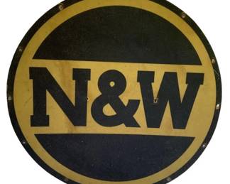696 - Norfolk & Western Railway Plexiglass Sign 24" (Description): N&W plexi-glass sign featuring the classic Norfolk and Western Railway logo design in black and gold. Measures 24 inches in diameter.