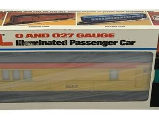 851 - Lionel O Gauge Special Combo Car in Box (Description): Lionel Special Combo Car in O Scale, complete in original box. This illuminated passenger car is designed for O and 027 gauge layouts. The car features a yellow and orange Union Pacific-style color scheme with car number 9582 visible on the side. Box displays product information and images of other available passenger cars in the series.