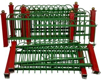 985 - Metal O-Scale Fencing 8"x11.25" (Description): Metal O-Scale fencing pieces featuring green decorative fence sections with red posts topped with gold ball finials. The fencing displays an arched design along the top with vertical bars below. Measures 8" x 11.25".