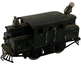 1126 - Antique O Scale Locomotive Toy (Description): Antique O scale locomotive toy in dark green/black painted metal finish. This early electric-style locomotive features a working bell, headlight bulb, cow catchers on both ends, window cutouts, and detailed door handles and vents. Shows authentic vintage wear with paint loss consistent with age and use. Measures 5.5" x 7" x 2.5".