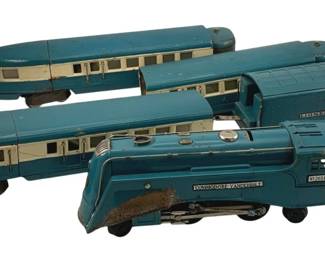 898 - 5pc Lionel Commodore Vanderbilt Train Set (Description): Five-piece Lionel Commodore Vanderbilt train set, #8049 scale. The set features a streamlined Art Deco-style locomotive with matching passenger cars and tender, finished in a distinctive blue and cream color scheme. The locomotive displays the 'Commodore Vanderbilt' nameplate on the side. Measures 2" x 9".