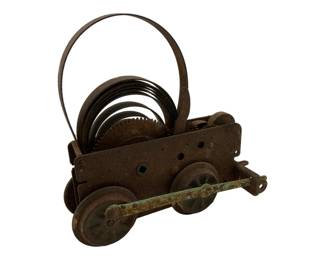742 - Vtg Clock Motor for Tinplate Trains (Description): Vintage clock motor designed for tinplate trains. This mechanical component features visible gears, wheels, and a coiled spring mechanism. Measures 5 inches by 4.5 inches by 2.25 inches.