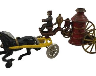 902 - Cast Iron Horse & Fire Buggy 13"x5"x3" (Description): Antique cast iron horse-drawn fire pumper toy featuring a single black horse pulling a yellow cart with a red boiler pump and yellow spoke wheels. A fireman figure sits atop the apparatus holding the reins. The piece displays original paint with typical wear consistent with age. Measures 13 inches long by 5 inches high by 3 inches wide.