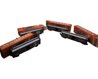 247 - Group Lot of 4 Marklin Train Cars 2"x2"x8" (Description): With original boxes. Each car measures 2 inches by 2 inches by 8 inches.
