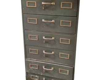 450 - Shaw-Walker 6 Drawer Metal File Cabinet (Description): Six drawer metal file cabinet by Shaw-Walker. Each drawer features a center pull handle and label holder slots. Measures 43 inches high by 20 inches wide by 27 inches deep.