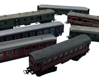 283 - Group Lot of 7 Marklin Cargo Cars 1"x2"x7" (Description): These model train cars display various designs and colorways typical of European passenger and cargo rolling stock. Each car measures approximately 1" x 2" x 7".