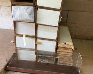 433 - Group Lot of 10 Display Cases for Trains (Description): Group lot of 10 display cases designed for trains. Each case measures 7 x 25.5 x 5.5 inches. Cases feature clear acrylic fronts with wood-tone frames, ideal for showcasing model train collections.