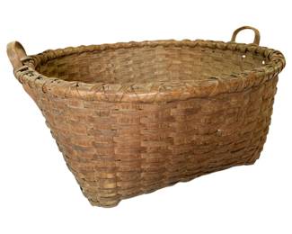 47 - Primitive Large Splint Basket w/ Handles (Description): Primitive large splint basket with handles, featuring traditional woven construction. The basket displays a natural brown patina consistent with age and use. It has a rounded rectangular form with bentwood handles on each end and a wrapped rim. Measures 13" x 26".