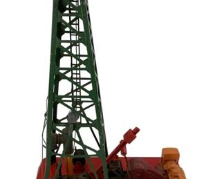 936 - Lionel No. 455 Oil Derrick/Pumper (Description): Lionel No. 455 Oil Derrick/Pumper. This vintage train accessory features a green lattice derrick tower with working pumper mechanism mounted on a red base with accompanying equipment. Measures 14 inches by 9.75 inches by 5 inches.