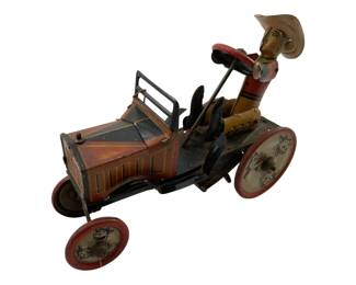 755 - Vtg Marx Whoopie Car Tin Wind-Up Toy (Description): Vintage Marx Whoopie Car tin lithograph wind-up toy featuring a cowboy figure driver. The toy depicts an early automobile with colorful lithographed details including character illustrations on the wheels. The piece shows wear and has damage consistent with age and play. Measures 6" x 9" x 3". Used as is electric/electronic/mechanical item. No guarantee all components, untested.