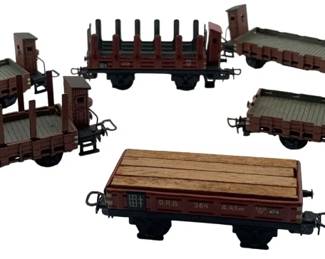 285 - Marklin Cargo & Lumber Cars 2"x2"x5" (Description): Marklin cargo and lumber cars. This set includes various freight car styles including open gondolas, a stake car, and a flatbed with lumber load. Each car measures 2 inches by 2 inches by 5 inches.