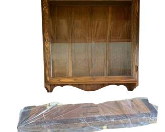 464 - Hanging Wood Wall Cabinet w/ Glass Shelves (Description): Hanging wood wall cabinet with top and glass shelves. The cabinet features a glass front door for display. Measures 24 inches wide by 32 inches tall by 7 inches deep.